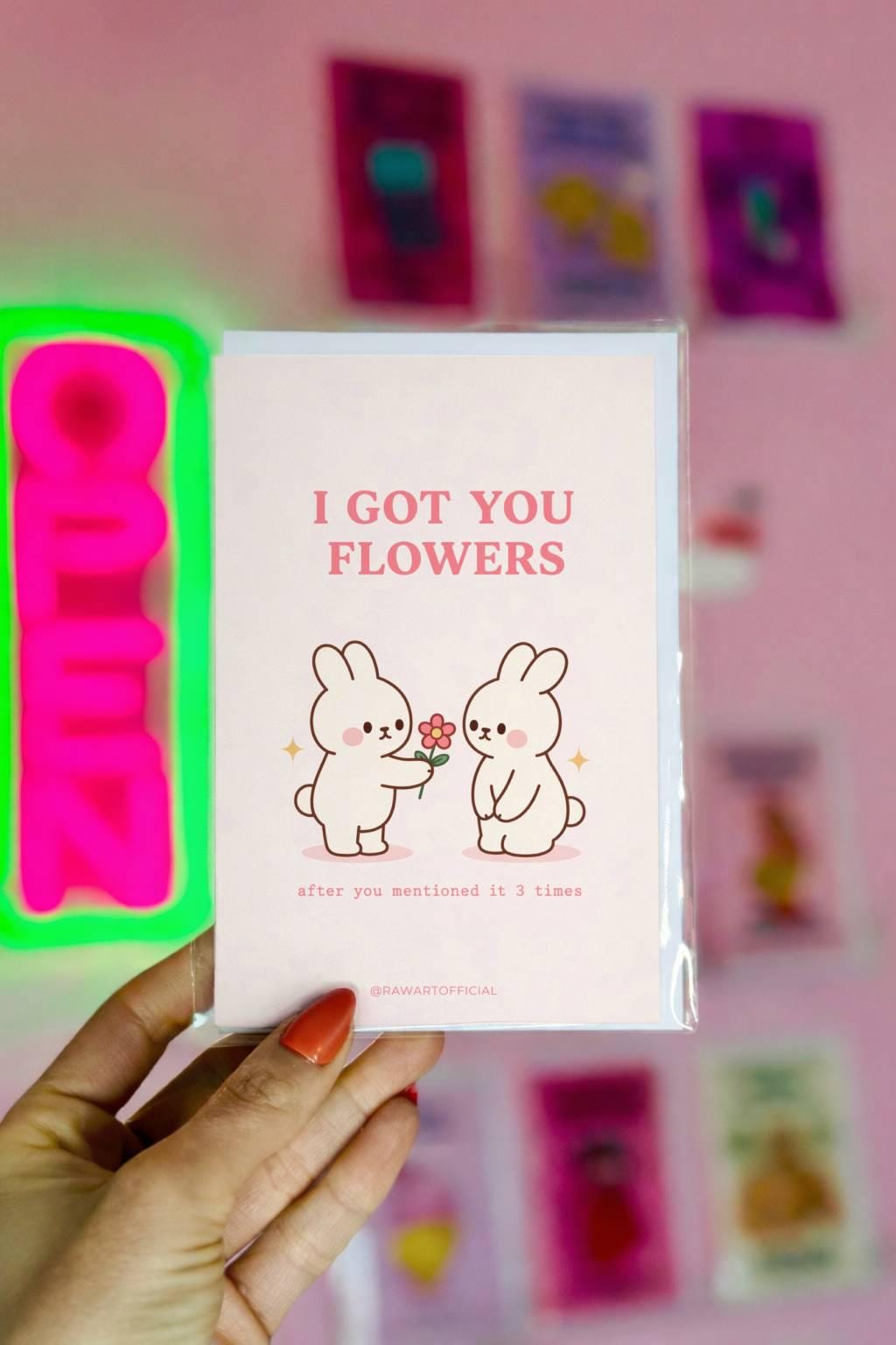 Cute bunny couple greeting card with text “I got you flowers after you mentioned it 3 times”