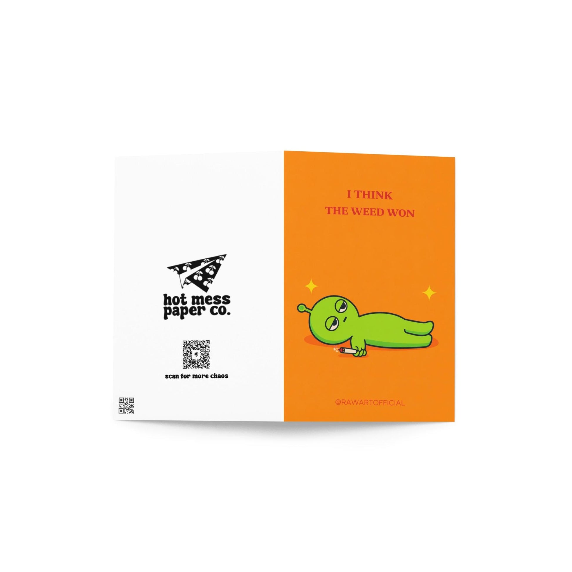 Funny stoner greeting card with green alien lying down holding joint, text says “I think the weed won” on orange background