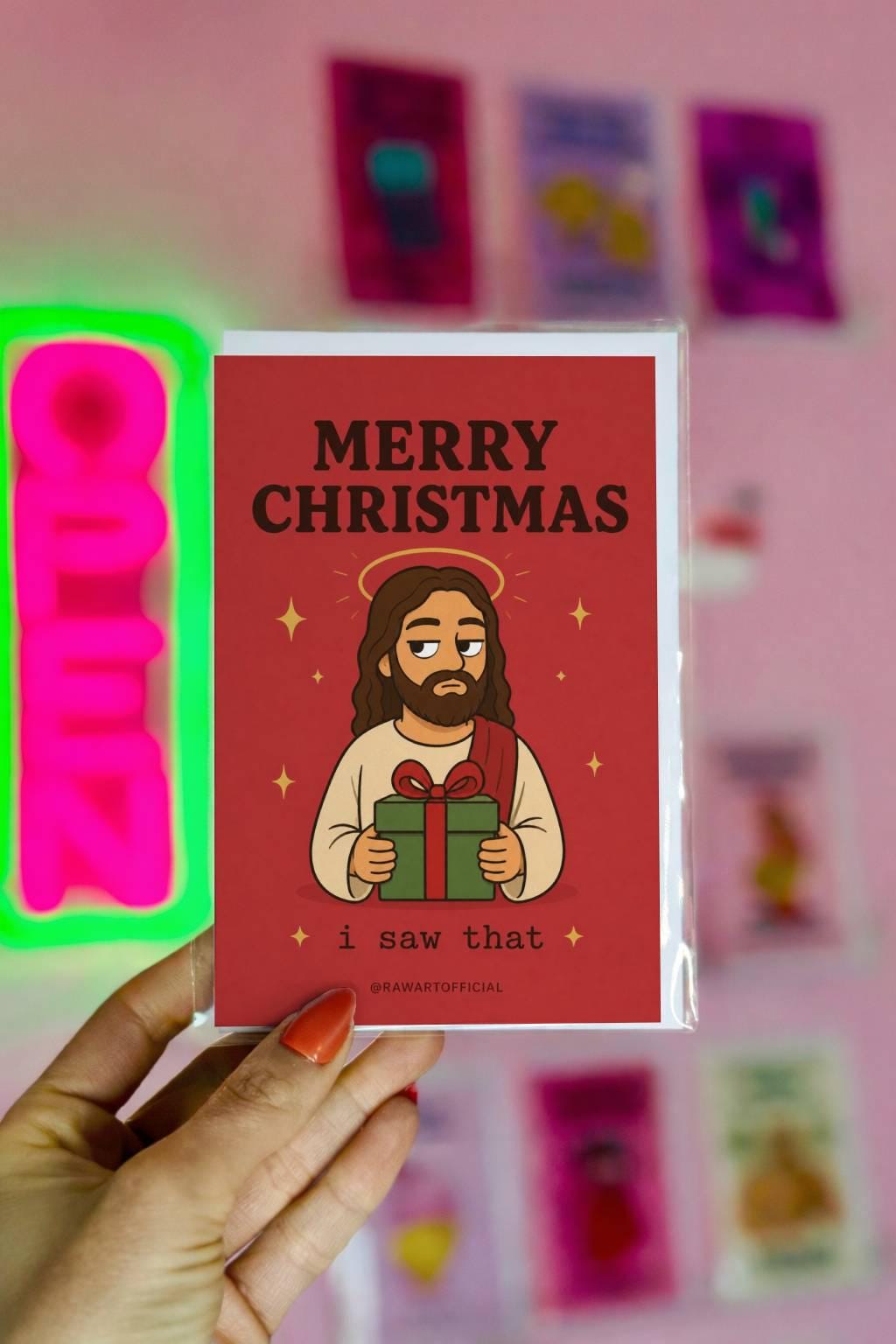 Funny Christmas greeting card with unimpressed Jesus holding a gift on red background saying “Merry Christmas, I Saw That”