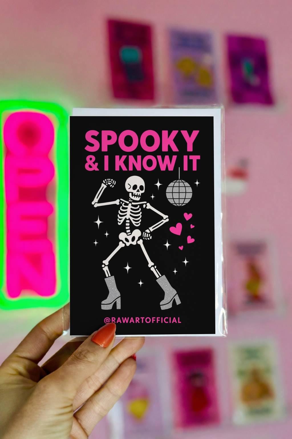 Funny Halloween greeting card with dancing skeleton in sparkly boots and disco ball on black background saying “Spooky & I Know It”