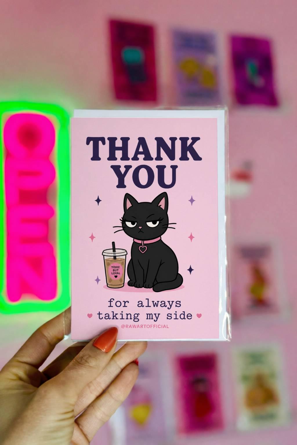 Funny black cat thank you card with iced coffee, text says “thank you for always taking my side”