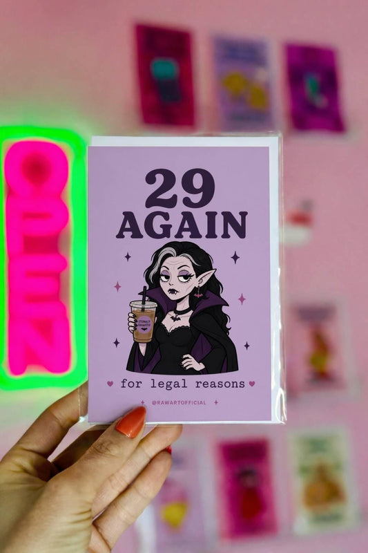 Funny goth vampire birthday card saying “29 again for legal reasons” holding iced coffee