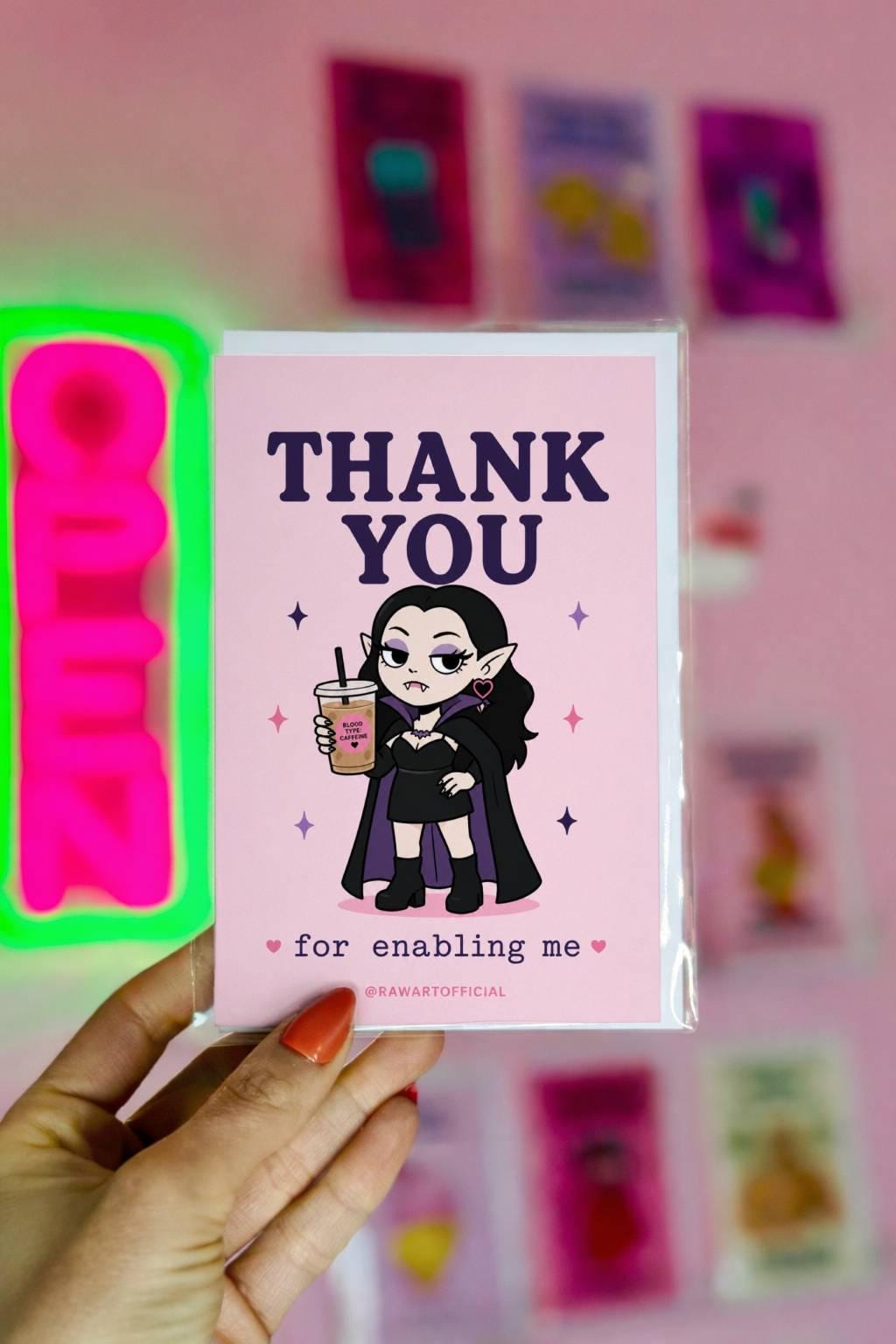 Funny goth vampire thank you card holding iced coffee, text says “thank you for enabling me”
