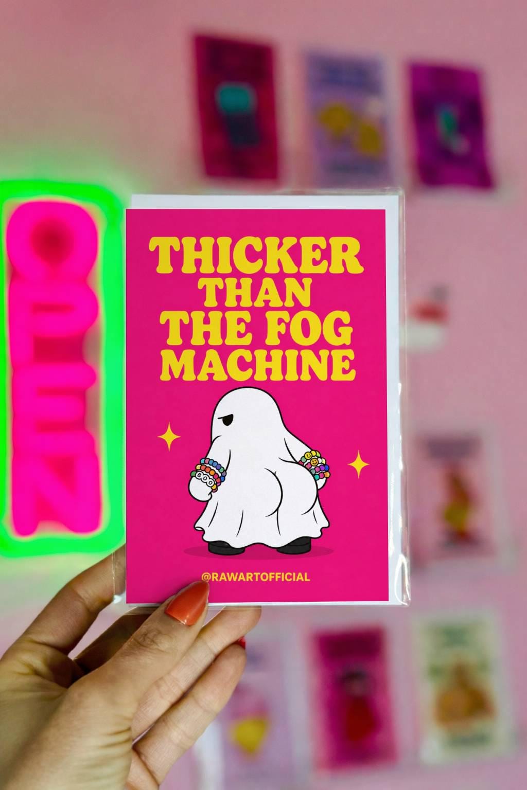 Funny Halloween rave greeting card with ghost wearing kandi bracelets on hot pink background saying “Thicker Than The Fog Machine”