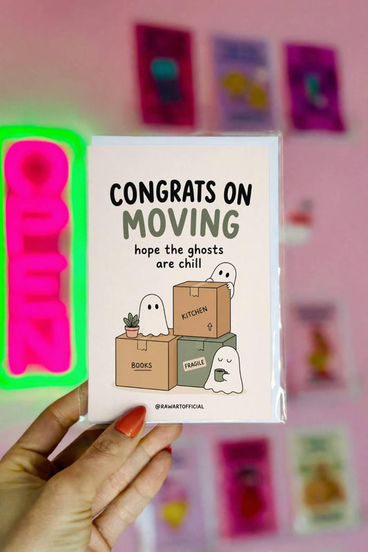 Funny moving card with cute ghosts unpacking boxes beside the phrase “Congrats On Moving Hope The Ghosts Are Chill.”