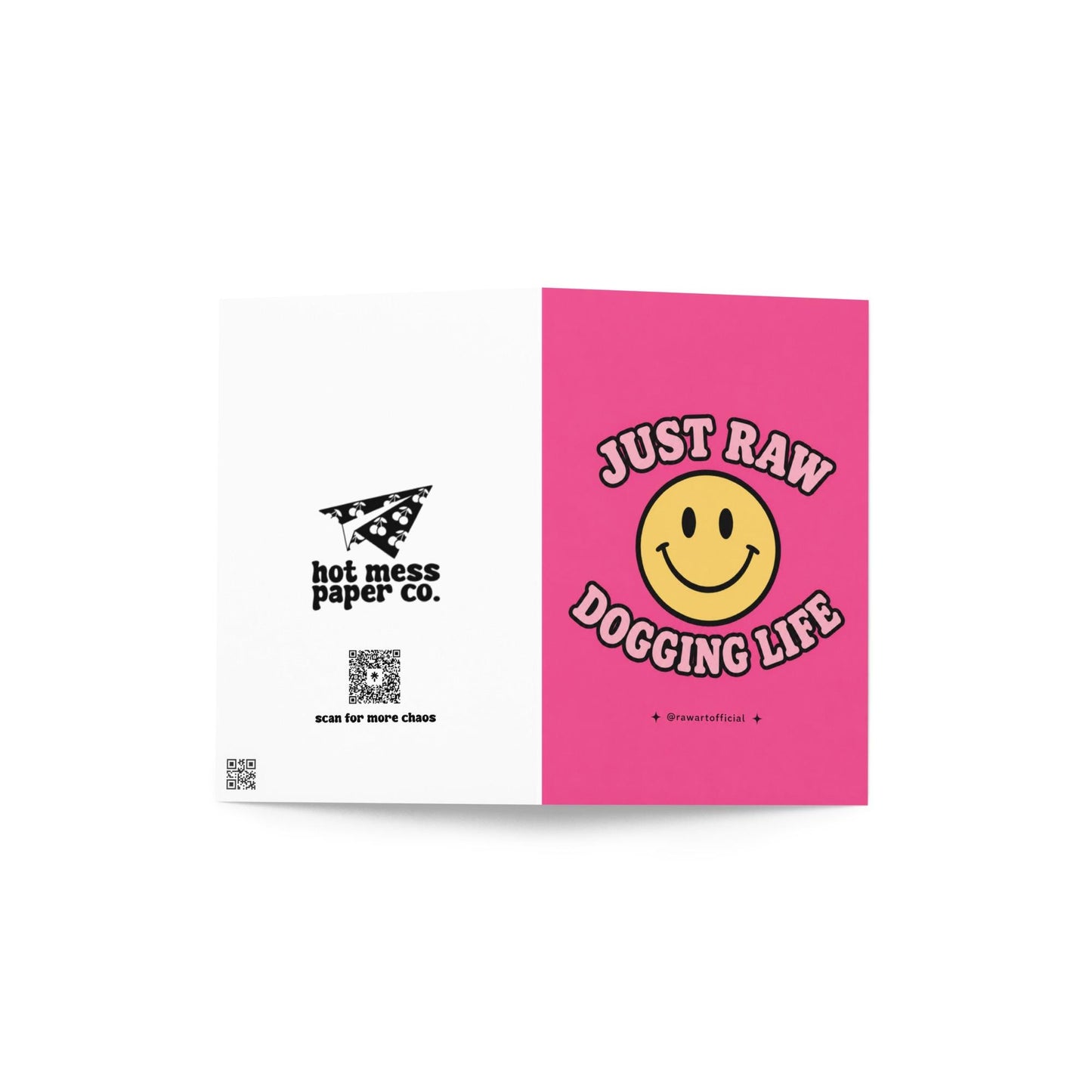 Funny pink greeting card with a retro smiley face and the text “Just Raw Dogging Life” in bubble lettering.