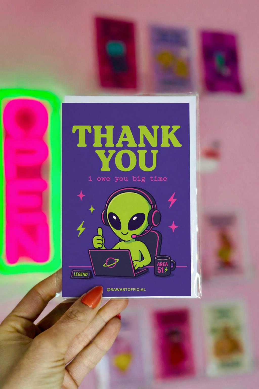 Funny coworker thank you greeting card with cartoon alien wearing headset at computer saying “Thank You, i owe you big time” on purple background.