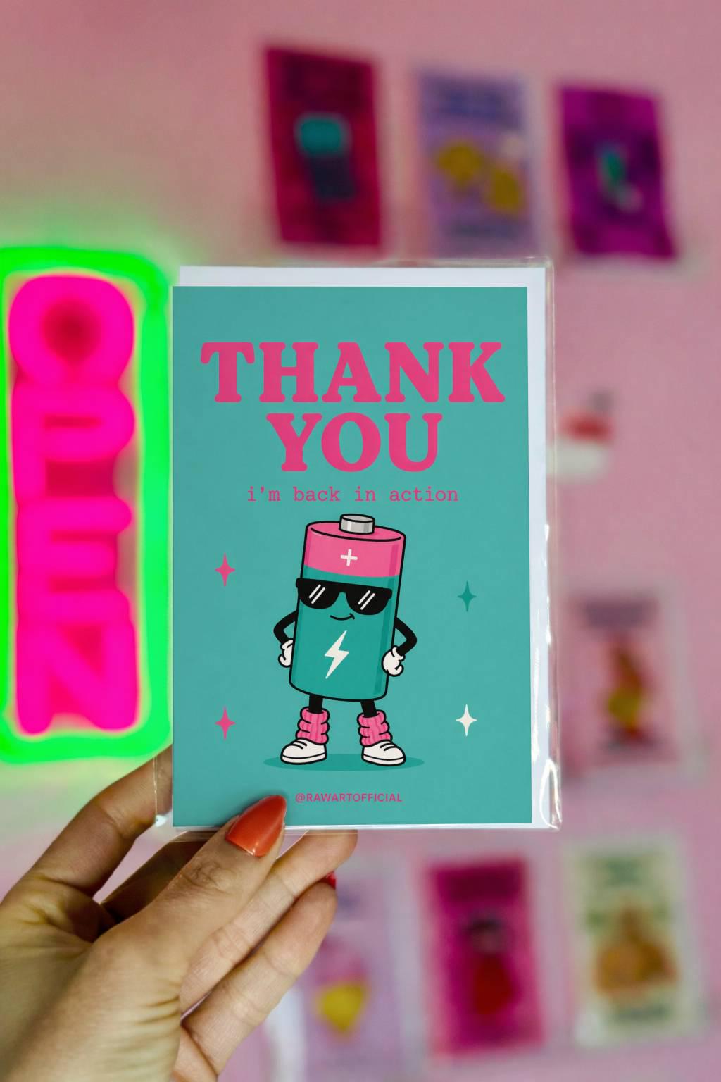 Funny coworker thank you greeting card with cartoon battery wearing sunglasses saying “Thank You, i’m back in action” on teal background.