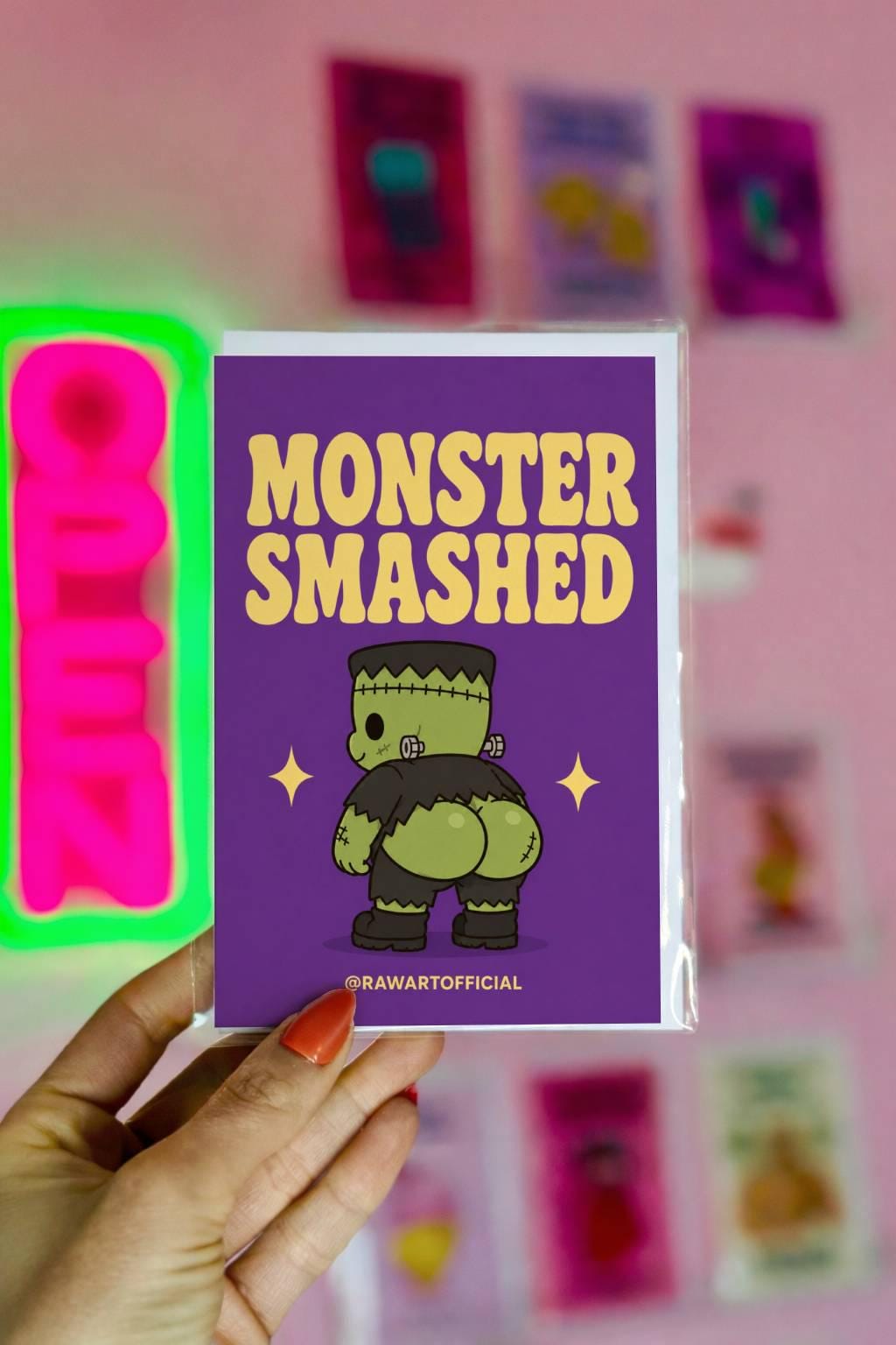 Funny Halloween greeting card with a cute Frankenstein monster from behind and the text “Monster Smashed” on a purple background.