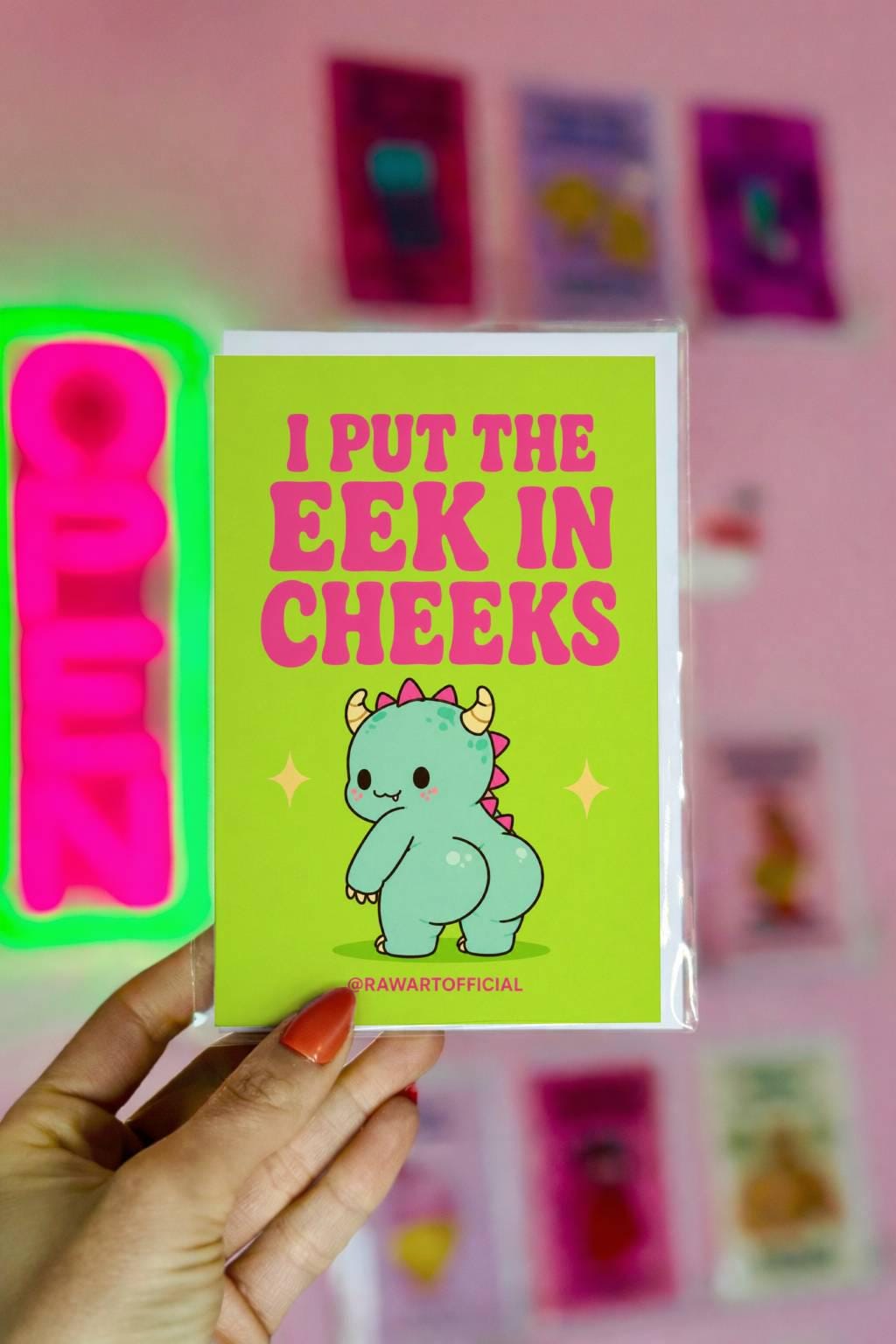 Funny Halloween greeting card with cute monster booty character and retro text reading “I Put the Eek in Cheeks” on slime green background.