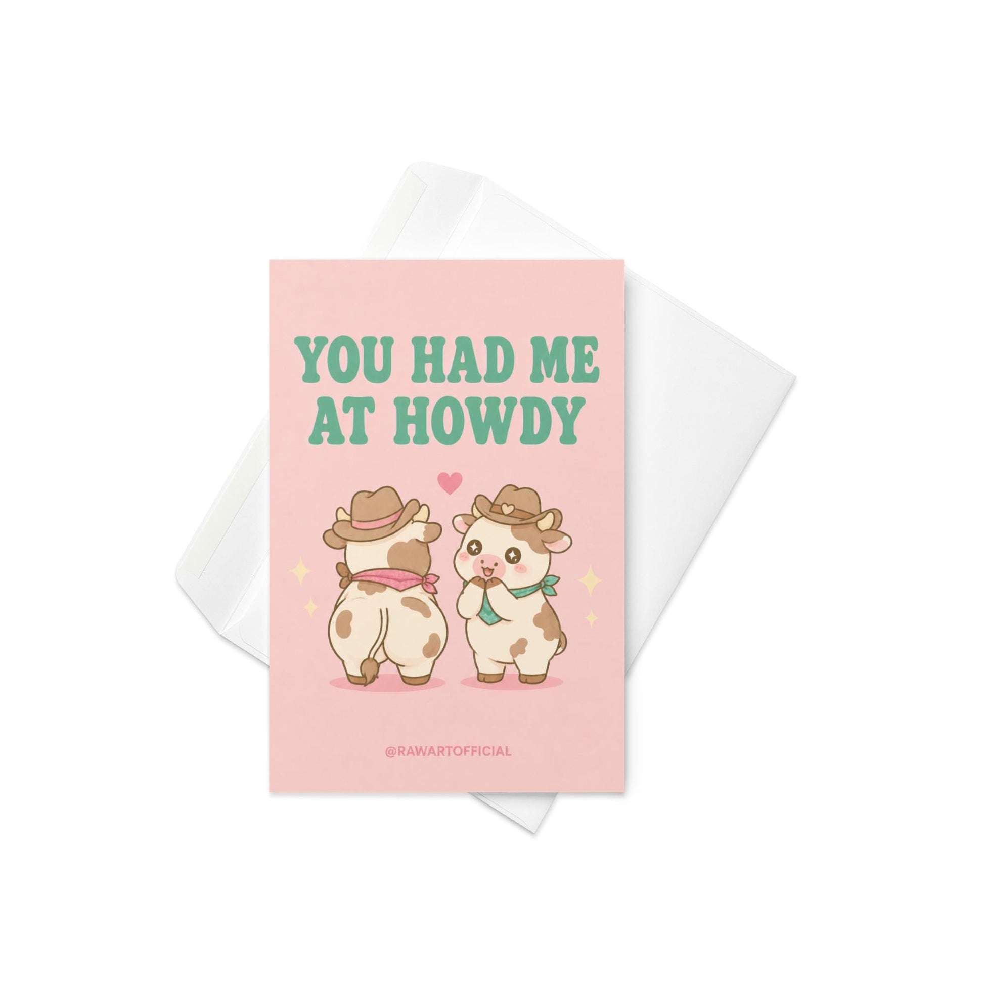 Funny love card featuring two adorable cowboy cows beside the phrase “You Had Me At Howdy,” including one cheeked-up cow and a heart above them.