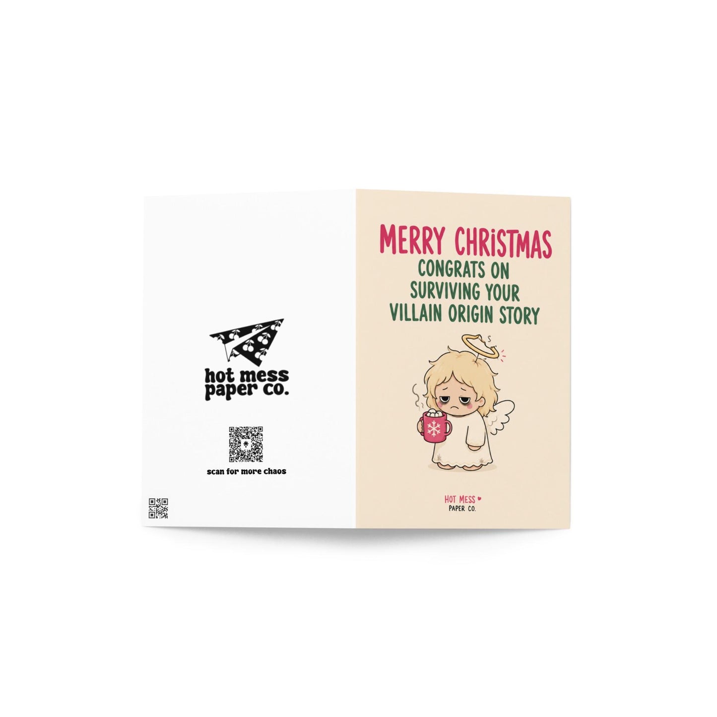 Funny Christmas card featuring a tired angel holding hot cocoa beside the phrase “Congrats On Surviving Your Villain Origin Story.”