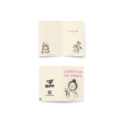 Funny divorce greeting card featuring a scribbly woman holding wine beside the phrase “Congrats on the Divorce” with humorous inside artwork including a flaming wedding cake.