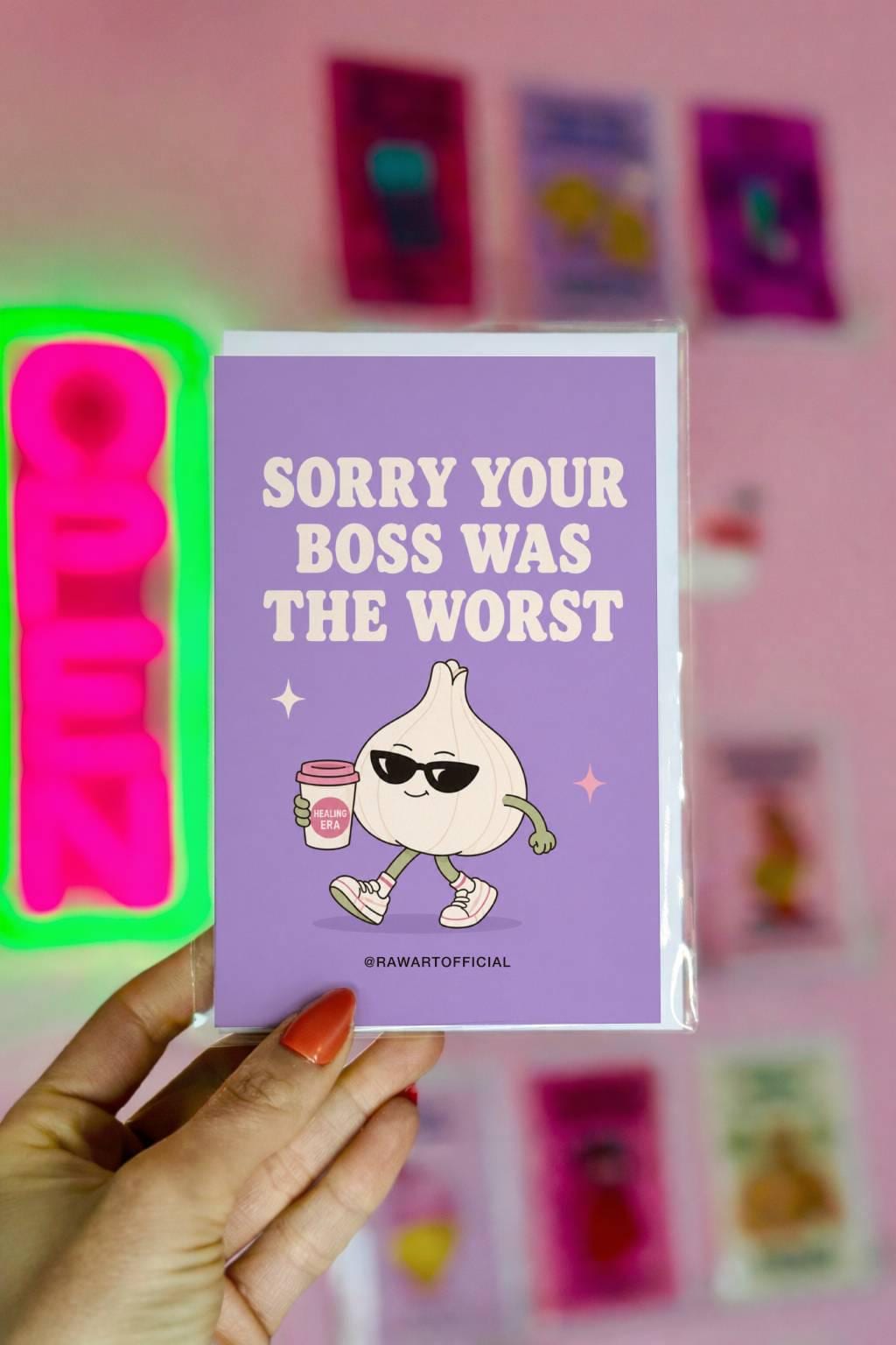 Funny quitting job card with a garlic clove in sunglasses holding coffee beside the phrase “Sorry Your Boss Was The Worst.”