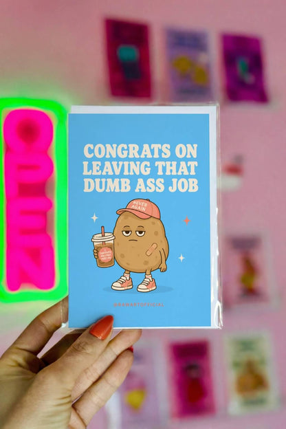 Funny quitting job card with a tired potato holding iced coffee beside the phrase “Congrats On Leaving That Dumb Ass Job.”