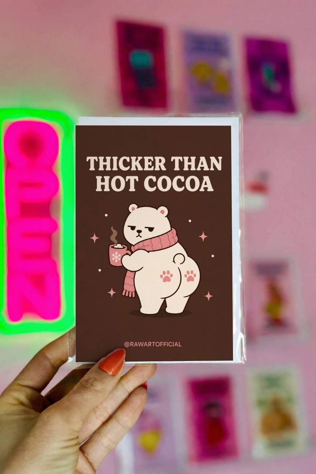 Funny Christmas card featuring a thick polar bear holding hot cocoa beside the phrase “Thicker Than Hot Cocoa.”