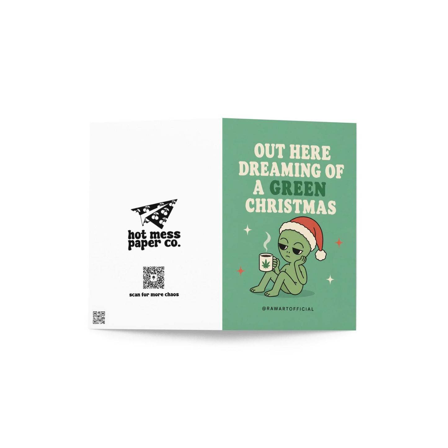 Funny Christmas card featuring an alien in a Santa hat holding a mug with a weed leaf beside the phrase “Out Here Dreaming Of A Green Christmas.”