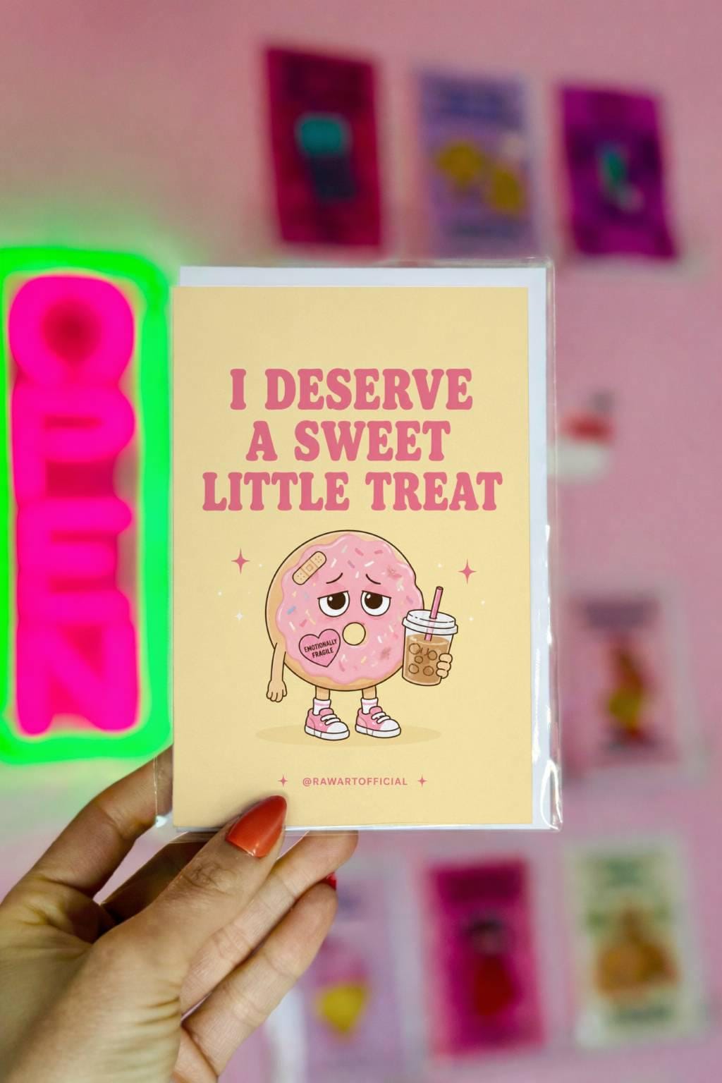 Funny donut card featuring a sad pink frosted donut holding iced coffee beside the phrase “I Deserve A Sweet Little Treat.”