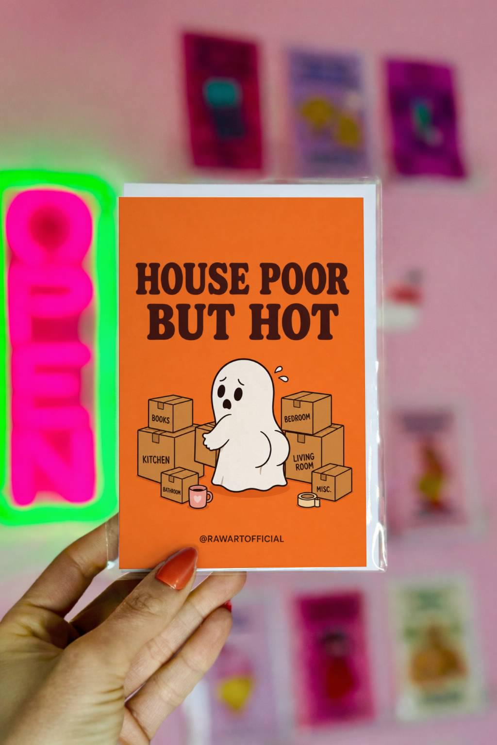 Funny new home card featuring a ghost surrounded by moving boxes beside the phrase “House Poor But Hot.” Humorous housewarming card for new homeowners.