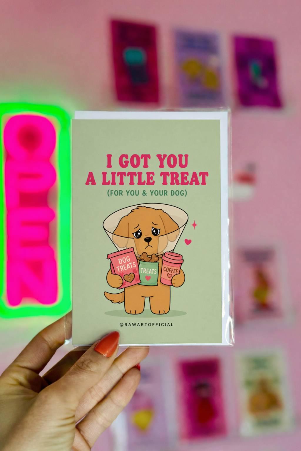 Funny dog lover card featuring a sad puppy in a cone holding treats and coffee beside the phrase “I Got You A Little Treat (For You & Your Dog).”