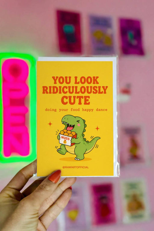 Funny greeting card featuring a happy dinosaur dancing with a box of chicken nuggets beside the phrase "You Look Ridiculously Cute Doing Your Food Happy Dance." Perfect for girlfriends, boyfriends, and food lovers.