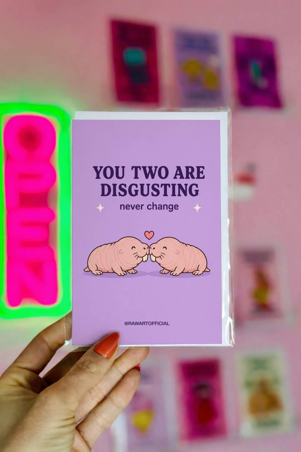 Funny wedding card featuring two cute naked mole rats nuzzling beneath a heart with the phrase “You Two Are Disgusting — Never Change.”