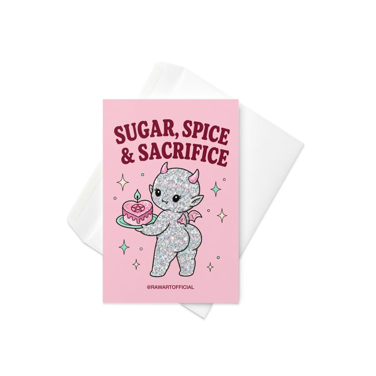 Pink funny Halloween greeting card reading “Sugar, Spice & Sacrifice” with a glittery cute devil holding a pink cake with a pentagram, photographed against a colorful pink card display.