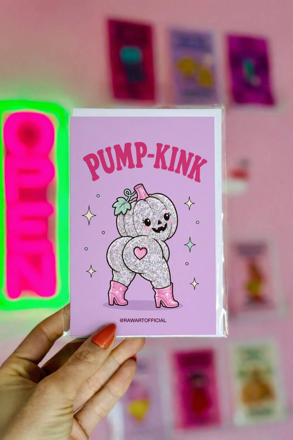Lavender Halloween greeting card reading "Pump-Kink" featuring a glittery pumpkin character in pink boots with a cute pumpkin face and playful booty design surrounded by sparkles.