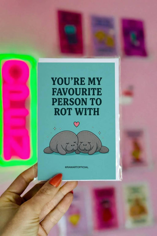 Funny love card featuring two cuddling manatees beneath the phrase “You’re My Favourite Person to Rot With.” Perfect for Valentine’s Day, anniversaries, and homebody couples.