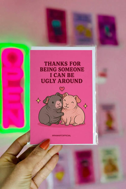 Funny greeting card featuring two cuddling guinea pigs beneath the phrase “Thanks for Being Someone I Can Be Ugly Around.”