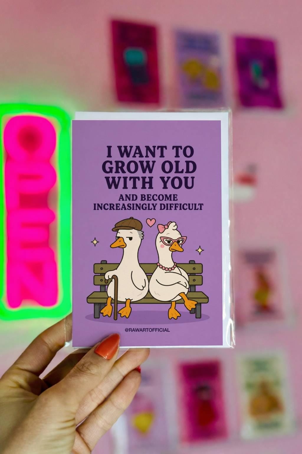 Funny anniversary card featuring two elderly geese sitting on a bench beside the phrase “I Want to Grow Old With You and Become Increasingly Difficult.”