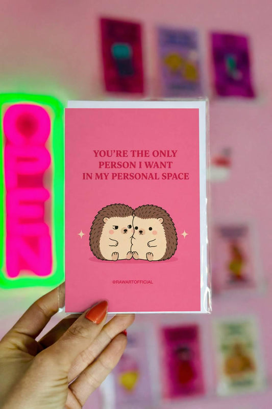 Funny love card featuring two cuddling hedgehogs beneath the phrase “You’re the Only Person I Want in My Personal Space.”