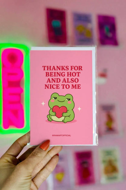 Funny love card featuring a green frog hugging a red heart beside the phrase “Thanks for Being Hot and Also Nice to Me.”