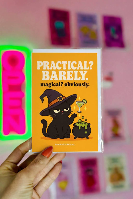 Funny witchy Halloween greeting card featuring a grumpy black cat wearing a witch hat beside a bubbling cauldron while magically levitating a margarita, with the phrase “Practical? Barely. Magical? Obviously.”