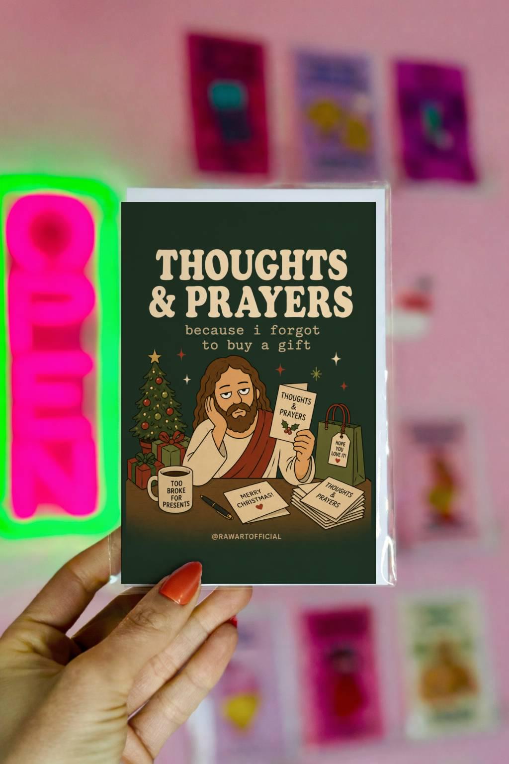 Funny Christmas card featuring Jesus at a Christmas table holding a Thoughts & Prayers card with gifts and a Christmas tree, reading “Thoughts & Prayers Because I Forgot to Buy a Gift.”