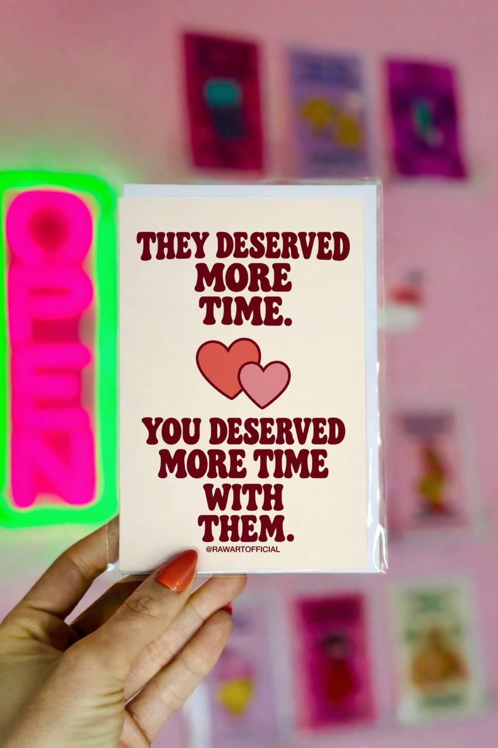 Heartfelt sympathy greeting card featuring two overlapping coral and pink hearts on a warm cream background. Bold burgundy retro lettering reads “They Deserved More Time. You Deserved More Time With Them.” Meaningful bereavement and condolence card for someone grieving the loss of a loved one, by Hot Mess Paper Co.