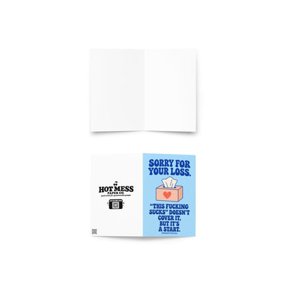 Unconventional sympathy greeting card with a pastel blue background and bold dark blue retro lettering reading “Sorry for Your Loss. This Fucking Sucks Doesn't Cover It, But It's a Start.” Features a peach-coloured tissue box with a coral heart and a white tissue sticking out. Honest, profanity-filled condolence card by Hot Mess Paper Co.