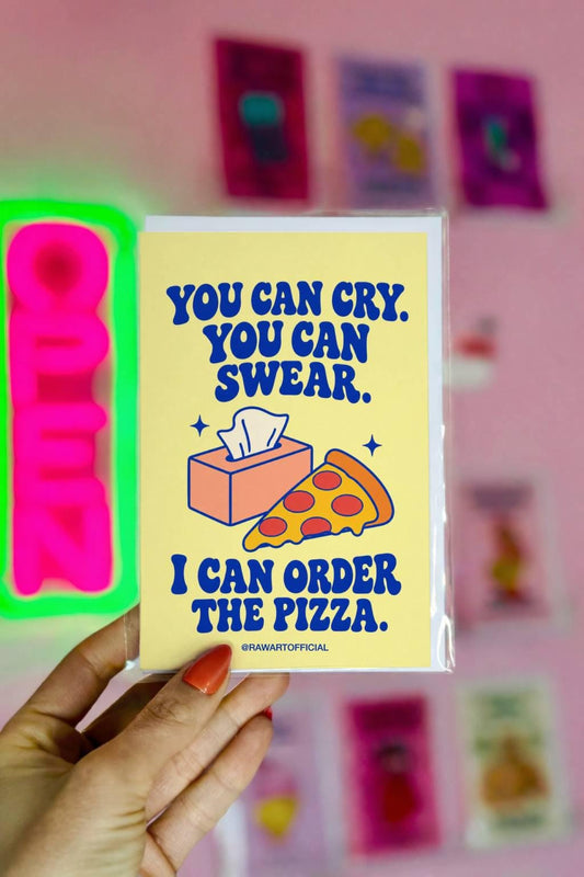 Unconventional sympathy greeting card featuring a peach-coloured tissue box and a slice of pepperoni pizza on a soft yellow background. Bold blue retro lettering reads “You Can Cry. You Can Swear. I Can Order the Pizza.” A heartfelt, lighthearted grief support card offering comfort and friendship during difficult times.