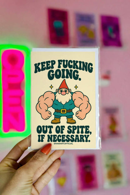 Funny encouragement greeting card featuring a muscular cartoon garden gnome with enormous flexing arms, an orange pointed hat, white beard, teal outfit, and brown boots. Cream background with bold dark green retro lettering reading “Keep Fucking Going. Out of Spite, If Necessary.” Sarcastic motivational card by Hot Mess Paper Co.