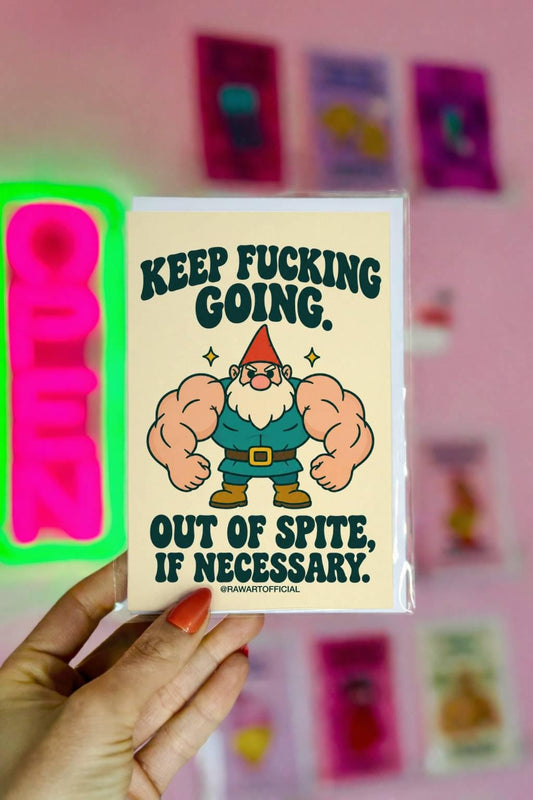 Funny encouragement greeting card featuring a muscular cartoon garden gnome with enormous flexing arms, an orange pointed hat, white beard, teal outfit, and brown boots. Cream background with bold dark green retro lettering reading “Keep Fucking Going. Out of Spite, If Necessary.” Sarcastic motivational card by Hot Mess Paper Co.