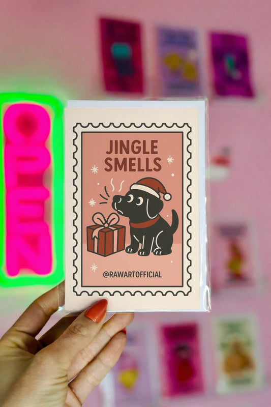 Funny Christmas card featuring a Labrador dog in a Santa hat sniffing a wrapped gift with text “Jingle Smells” in a retro style design