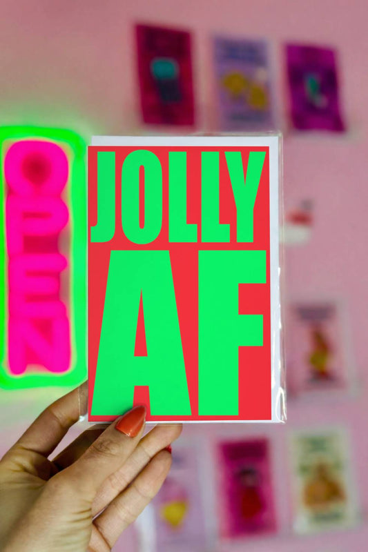 Funny Christmas greeting card with bold green text reading “Jolly AF” on a bright red background.