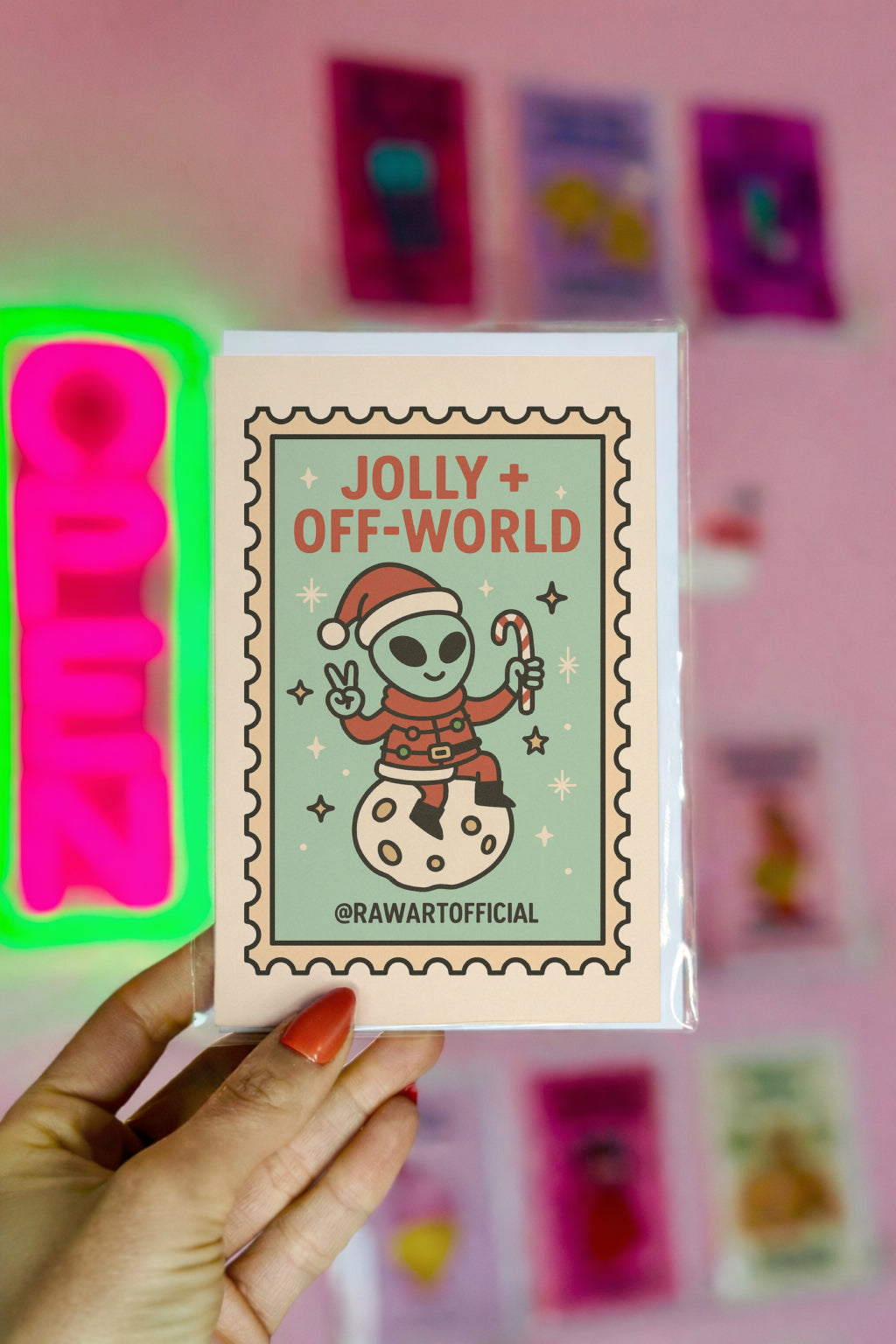 Cute alien Santa Christmas card sitting on moon with candy cane in retro stamp style.