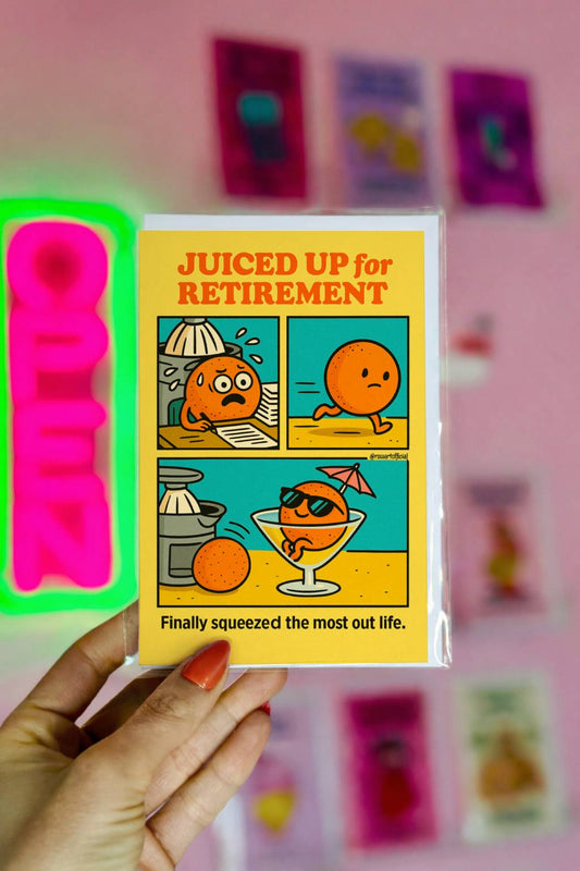 Funny retirement card showing a cartoon orange relaxing in a cocktail glass under a tiny umbrella with the caption “Juiced Up For Retirement.”