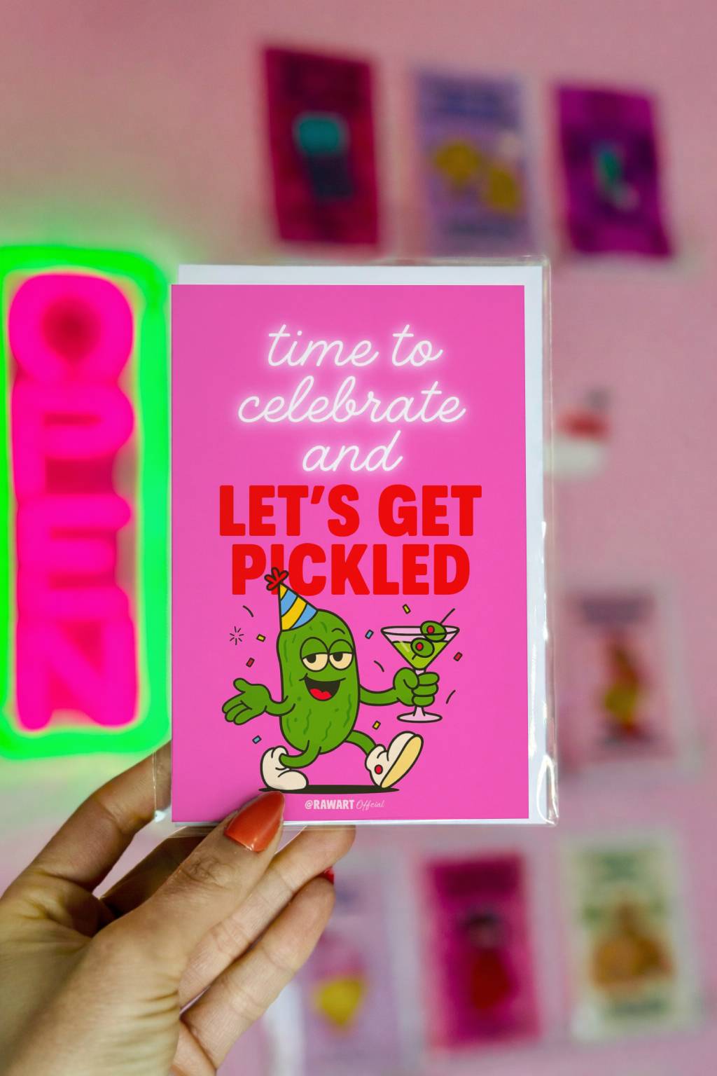 Bright pink birthday card featuring party pickle holding martini with text “Let’s Get Pickled.”