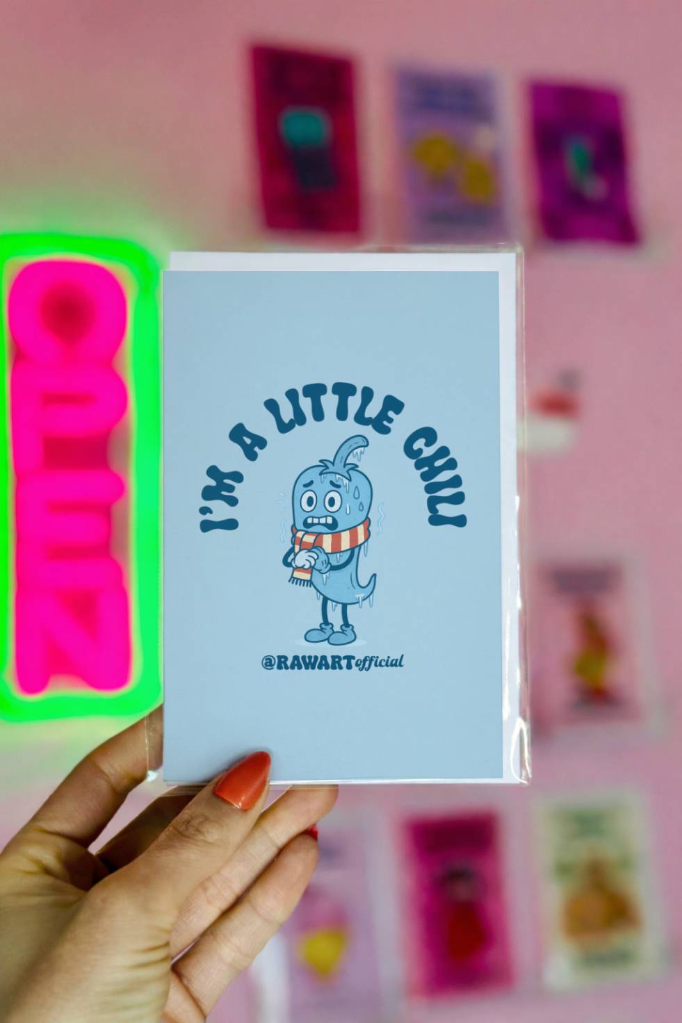 Funny Christmas greeting card featuring a shivering chili pepper wearing a scarf with text reading “I’m A Little Chili.”