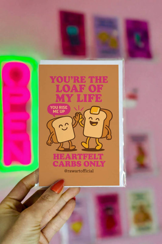 Greeting card with two smiling cartoon bread slices high-fiving under the text “You’re the Loaf of My Life.”