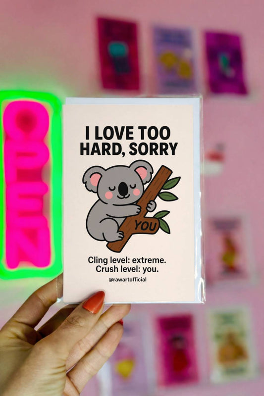 Funny greeting card with a cartoon koala hugging a tree branch labeled “you” with text “I Love Too Hard Sorry.”