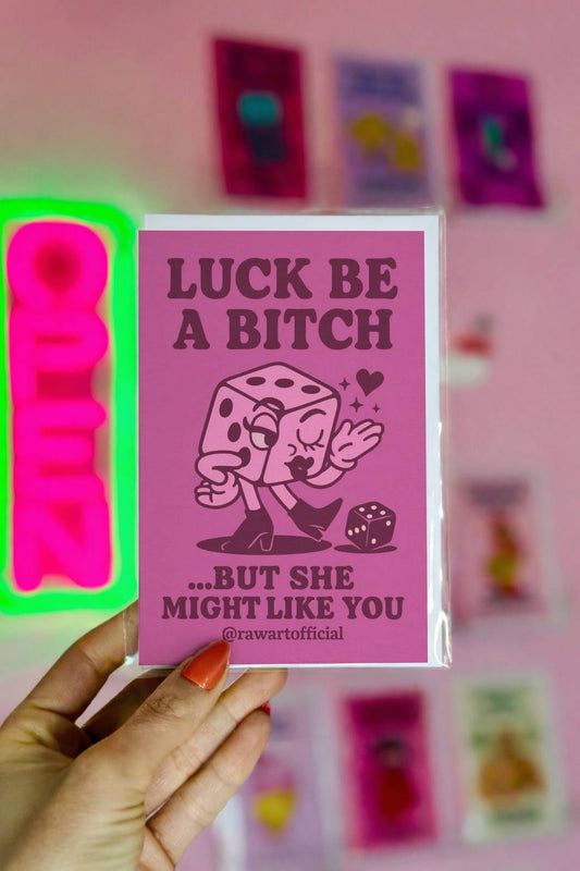 Greeting card featuring a cartoon dice character in heels with the text “Luck Be a Bitch… But She Might Like You.”