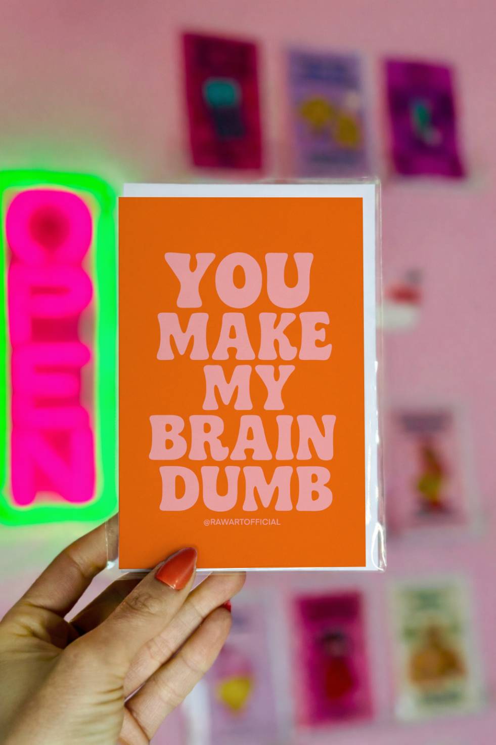 Minimalist funny Valentines card with orange background and text “You make my brain dumb.”